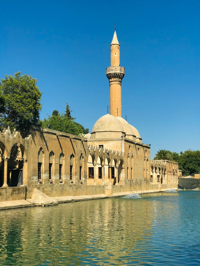 Picture of the ancient mosque at Balikligol, a historic landmark in Sanliurfa, Turkey, bathed in sunlight.